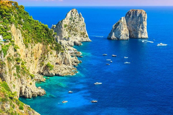 Enjoy the Capri Island with Its faraglioni cliffs while visiting Campania